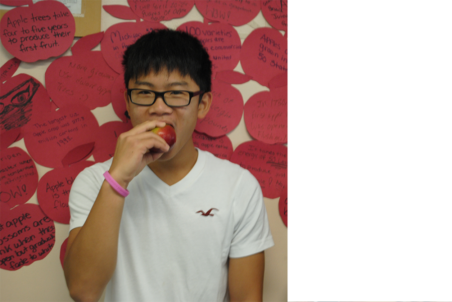 Sophomore,Zebin Guo enjoying an apple at Big Apple Crunch Day.