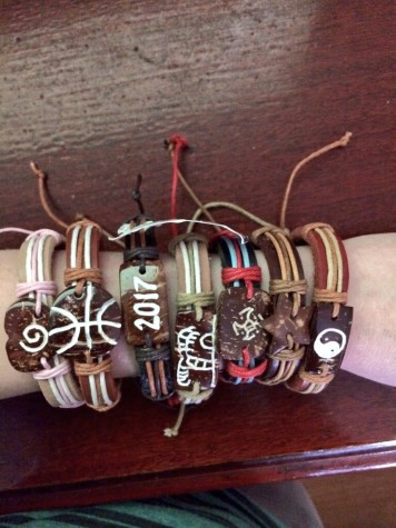 A student displays several bands on their arm.