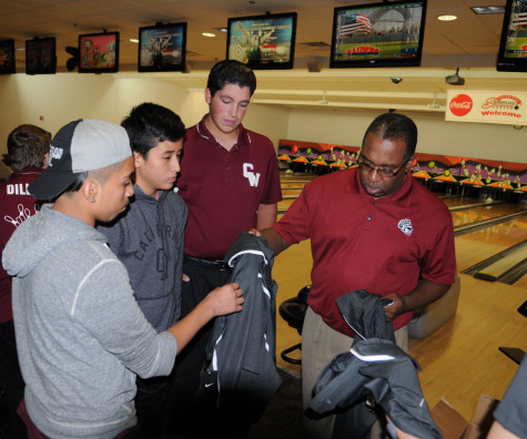 Mr. McGhie speaks to his team during a match.