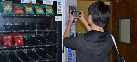 Johnnan Monzon Jr. using new vending machine scanner.