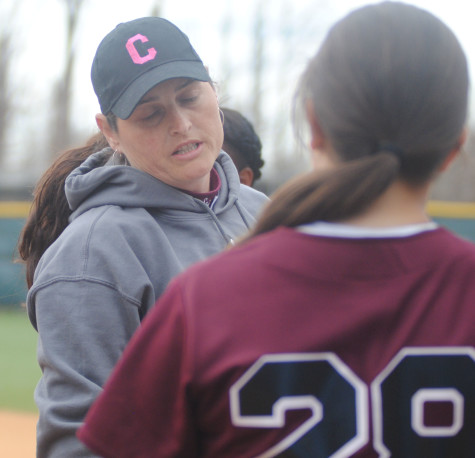 Coaching multiple sports, McNamara speaks to a softball player.