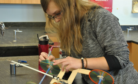 Junior, Michelle Pupkina putting last minute designs on her car.