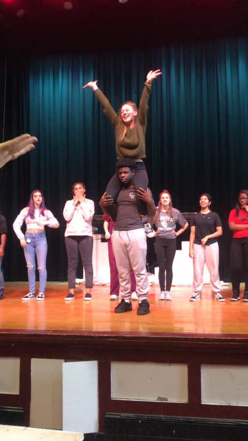 Members of the cast of Legally Blonde rehearsal a number in the Curtis auditorium. 