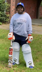 Cricket player Nadiya Kumaravel poses in her gear.