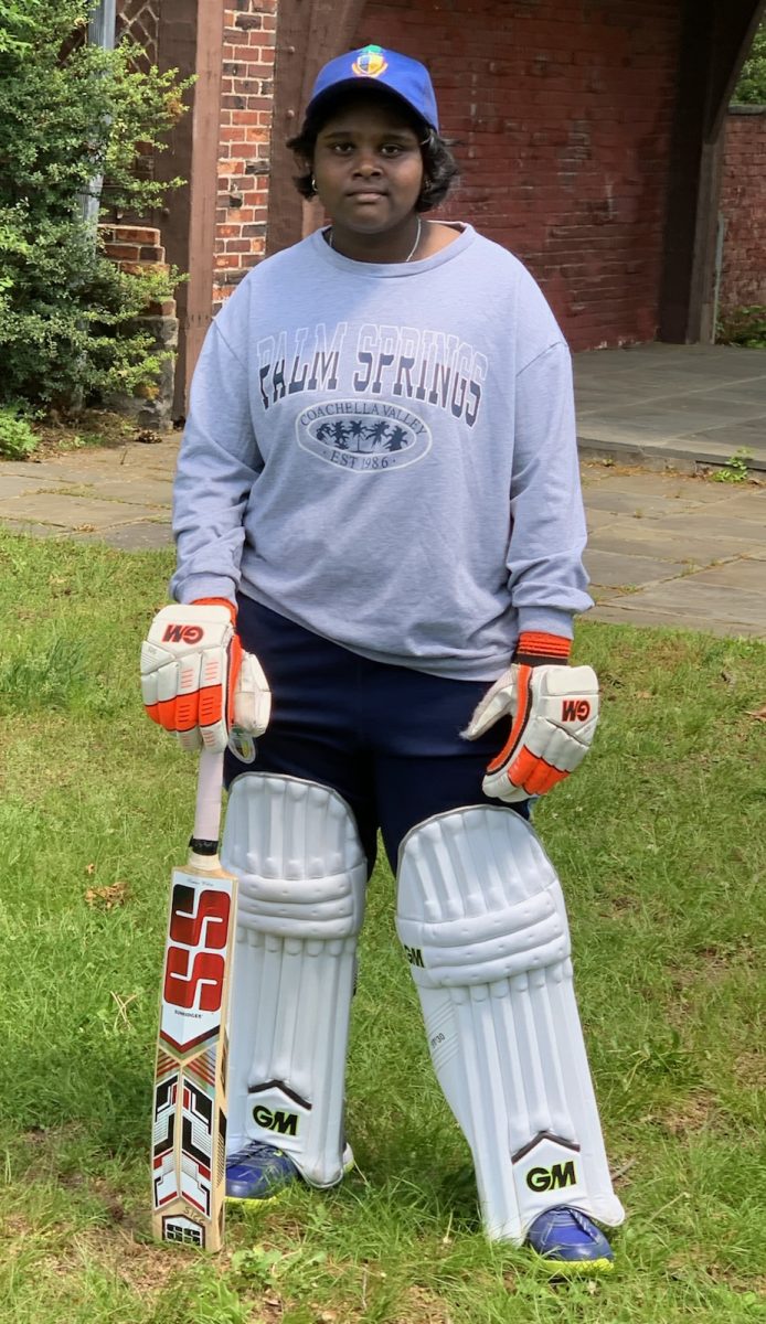 Cricket player Nadiya Kumaravel poses in her gear.