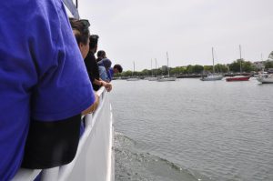 Students look on as the boat begins to move out of the bay.