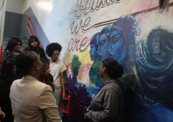 Kamillah Hanks and several art club members, view the mural after its completion.